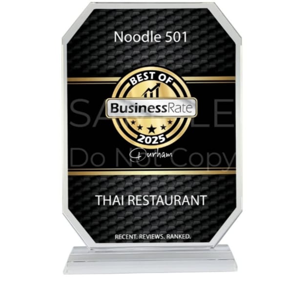 Noodle 501's "Best of BusinessRate 2025" award for Thai Restaurant, a black and gold plaque.
